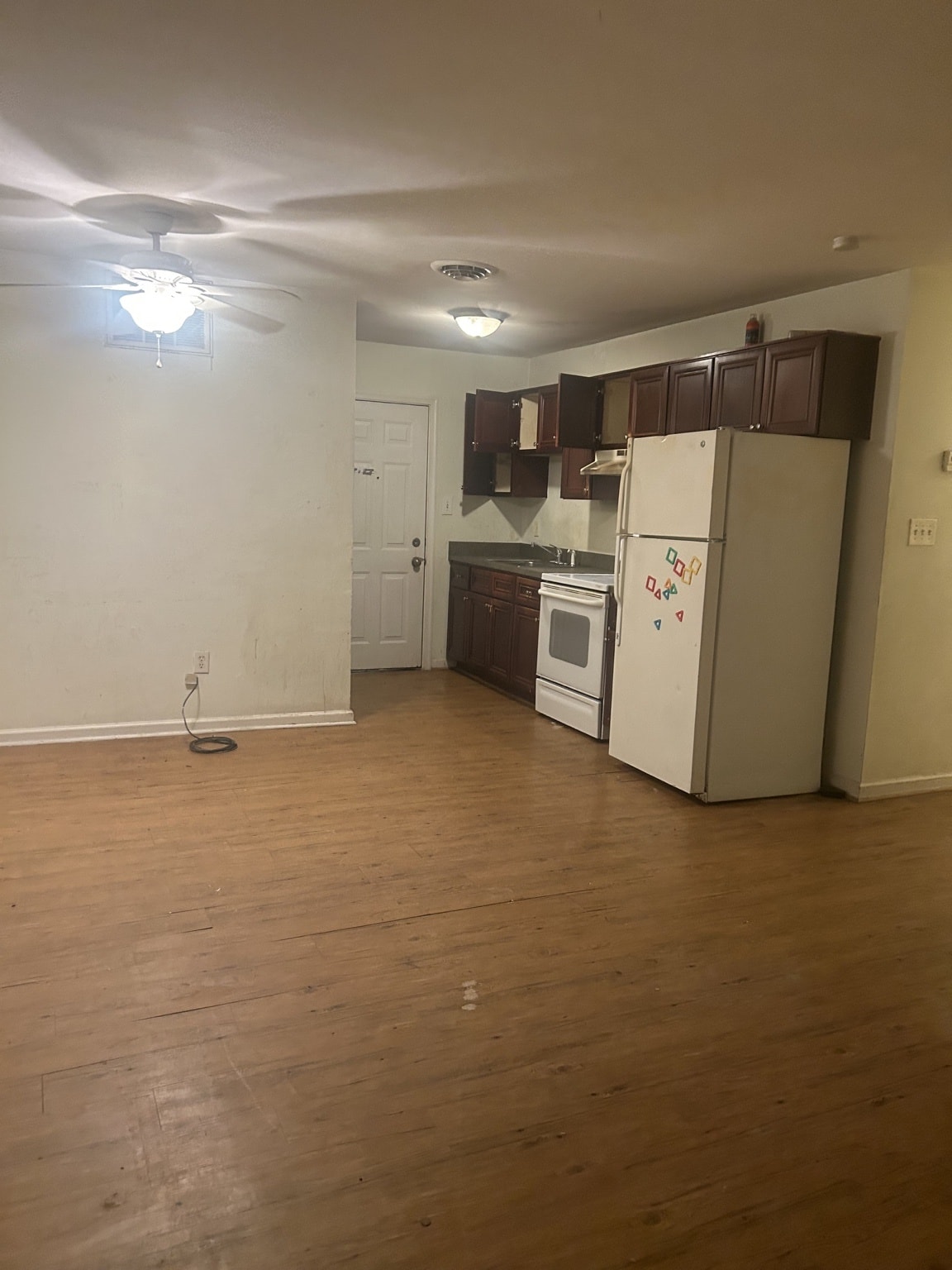 Before — dark cabinets, old appliances